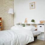 Bedroom with white bedding and shelving
