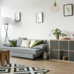 Bright living room with a grey sofa and storage shelves