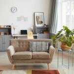 Living room with a beige loveseat and plants