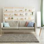 Living room with a beige sofa and white shelving