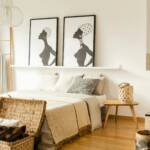 Bedroom with framed portraits above the bed